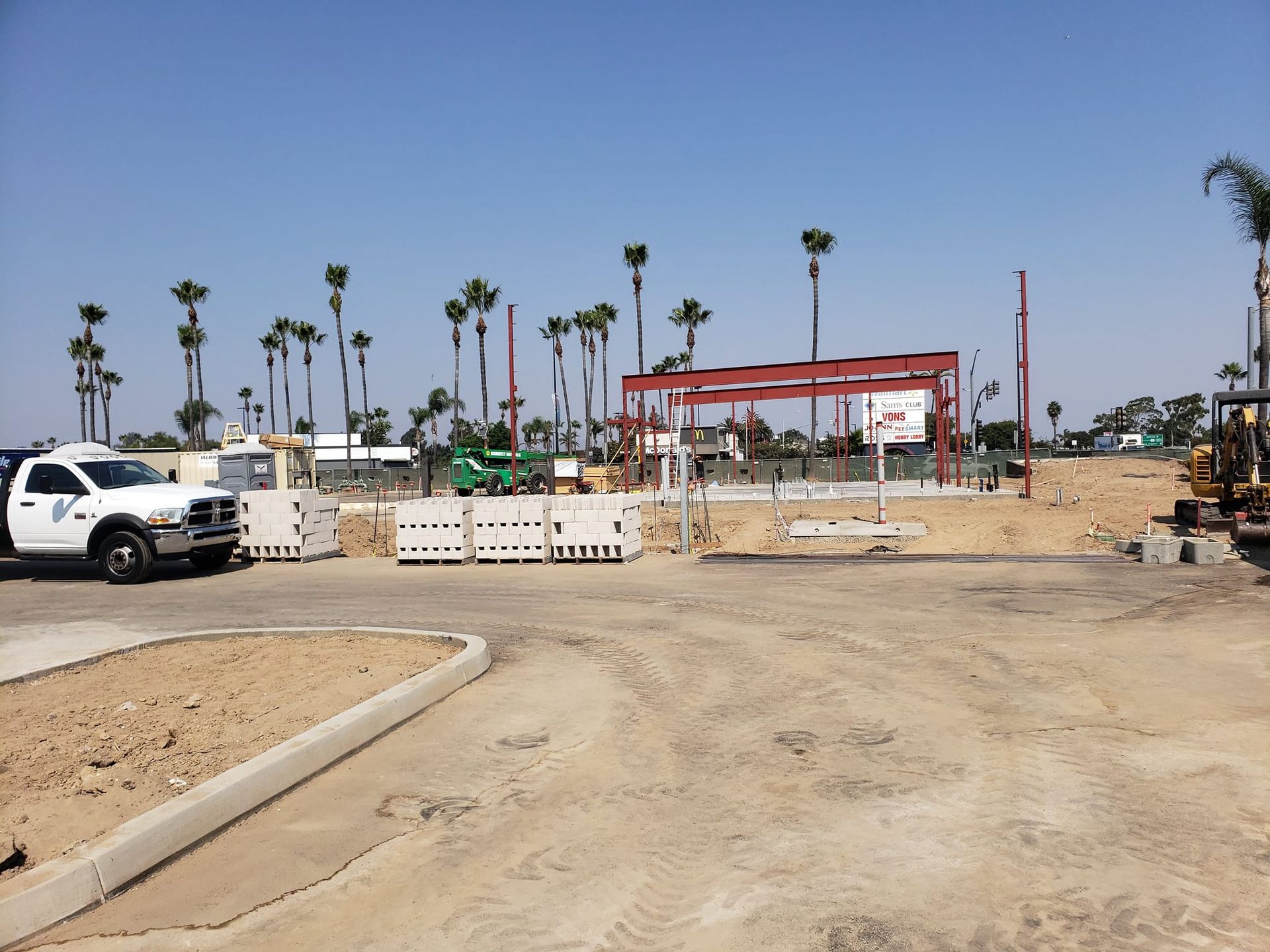 A white truck is parked in front of a construction site