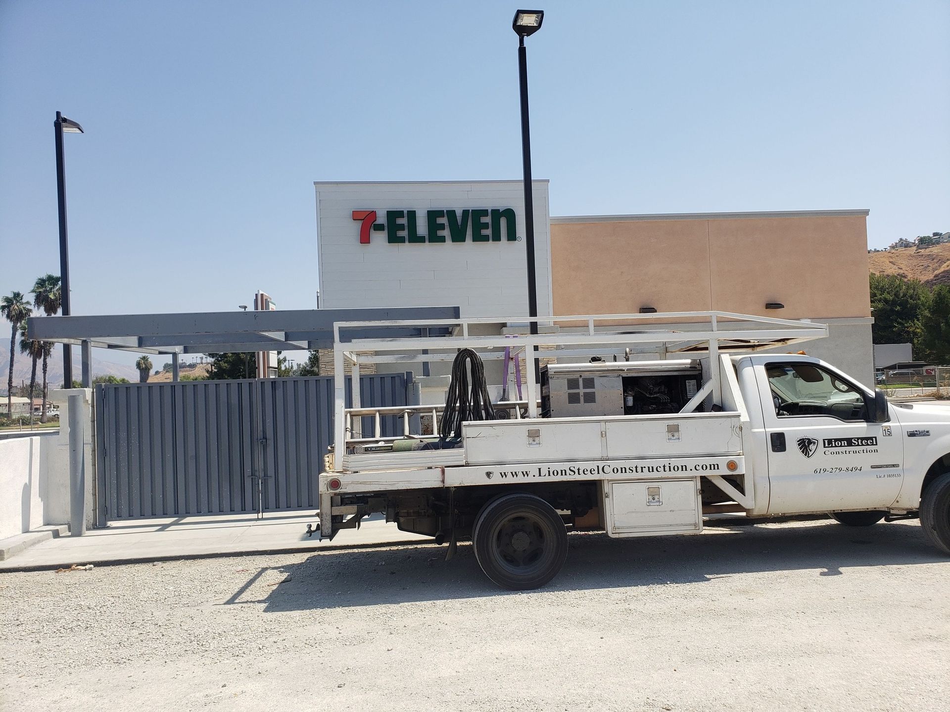A white truck is parked in front of a 7 eleven
