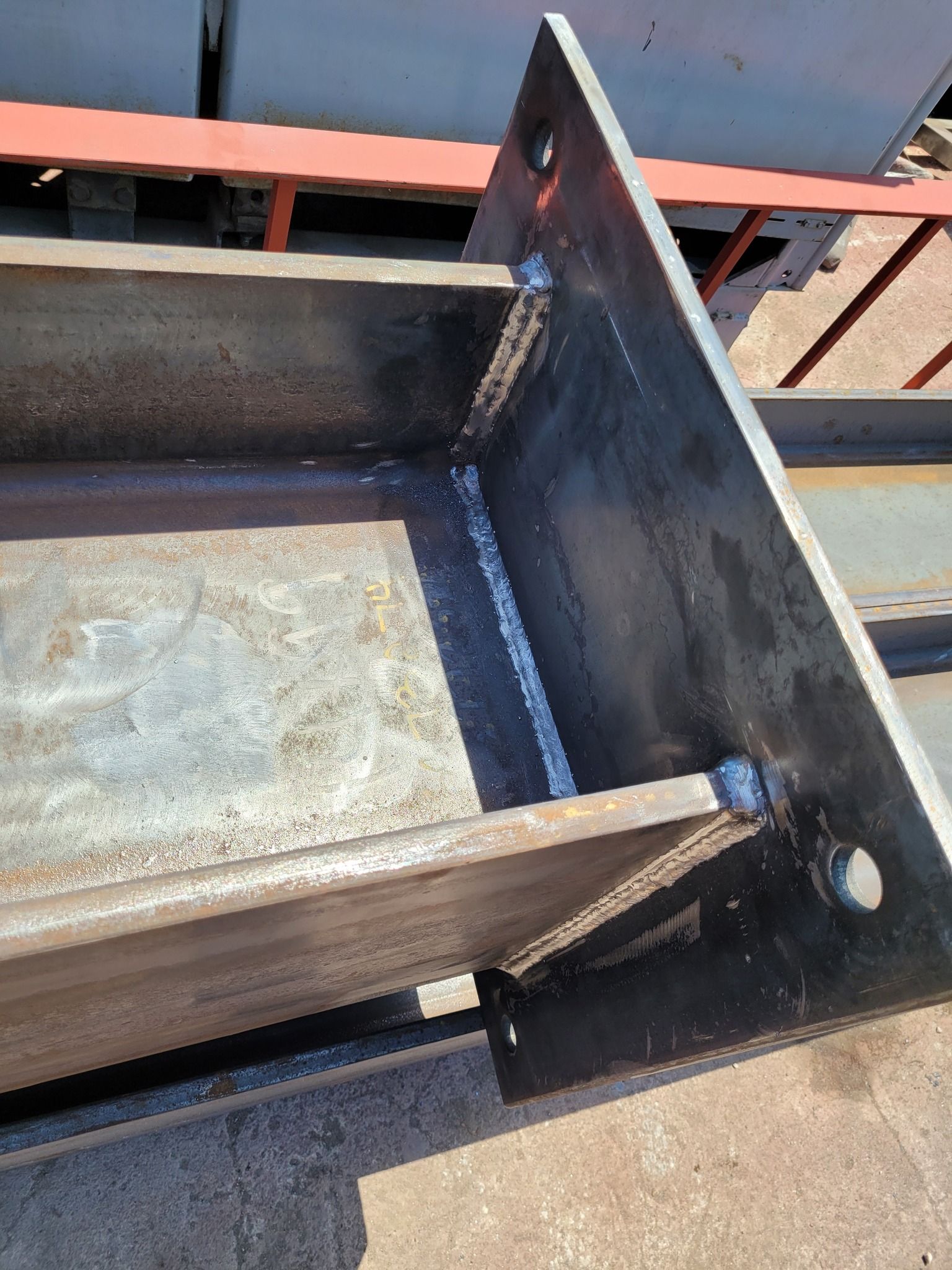 A close up of a metal beam sitting on top of a cement floor.