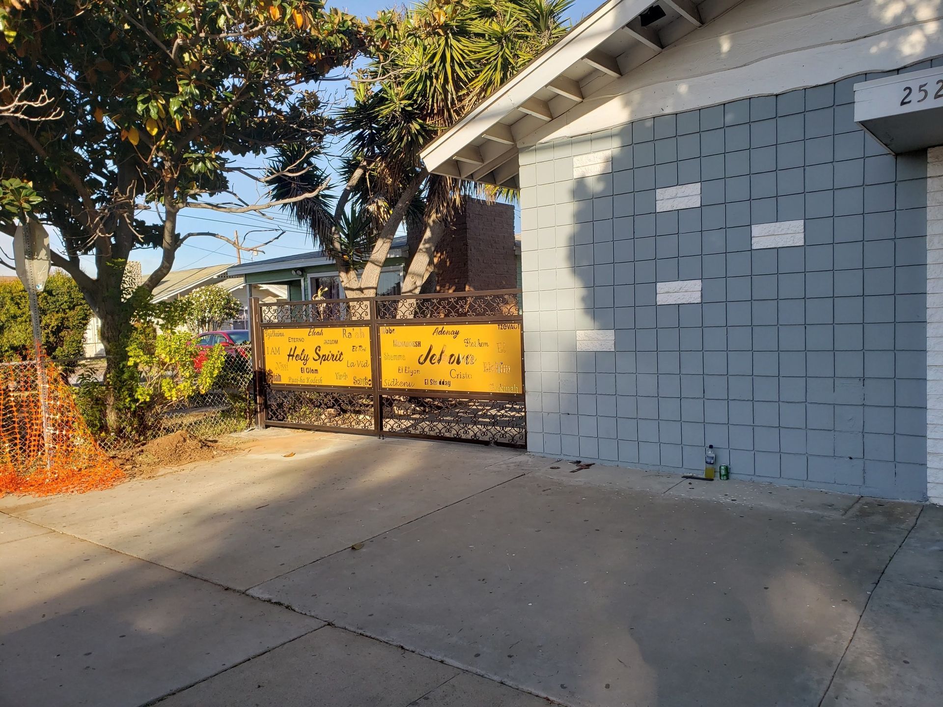 A house with a yellow gate that says ' army ' on it