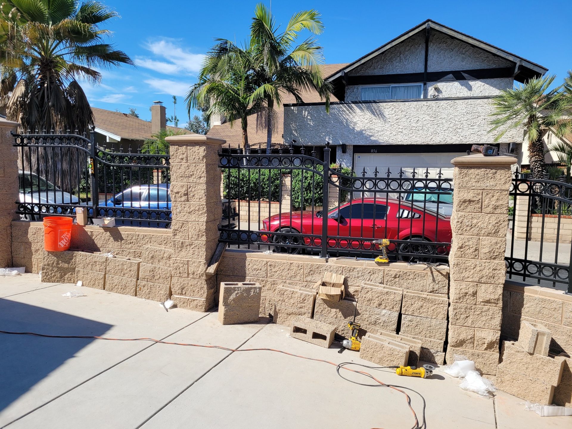 A red truck is parked in front of a house.