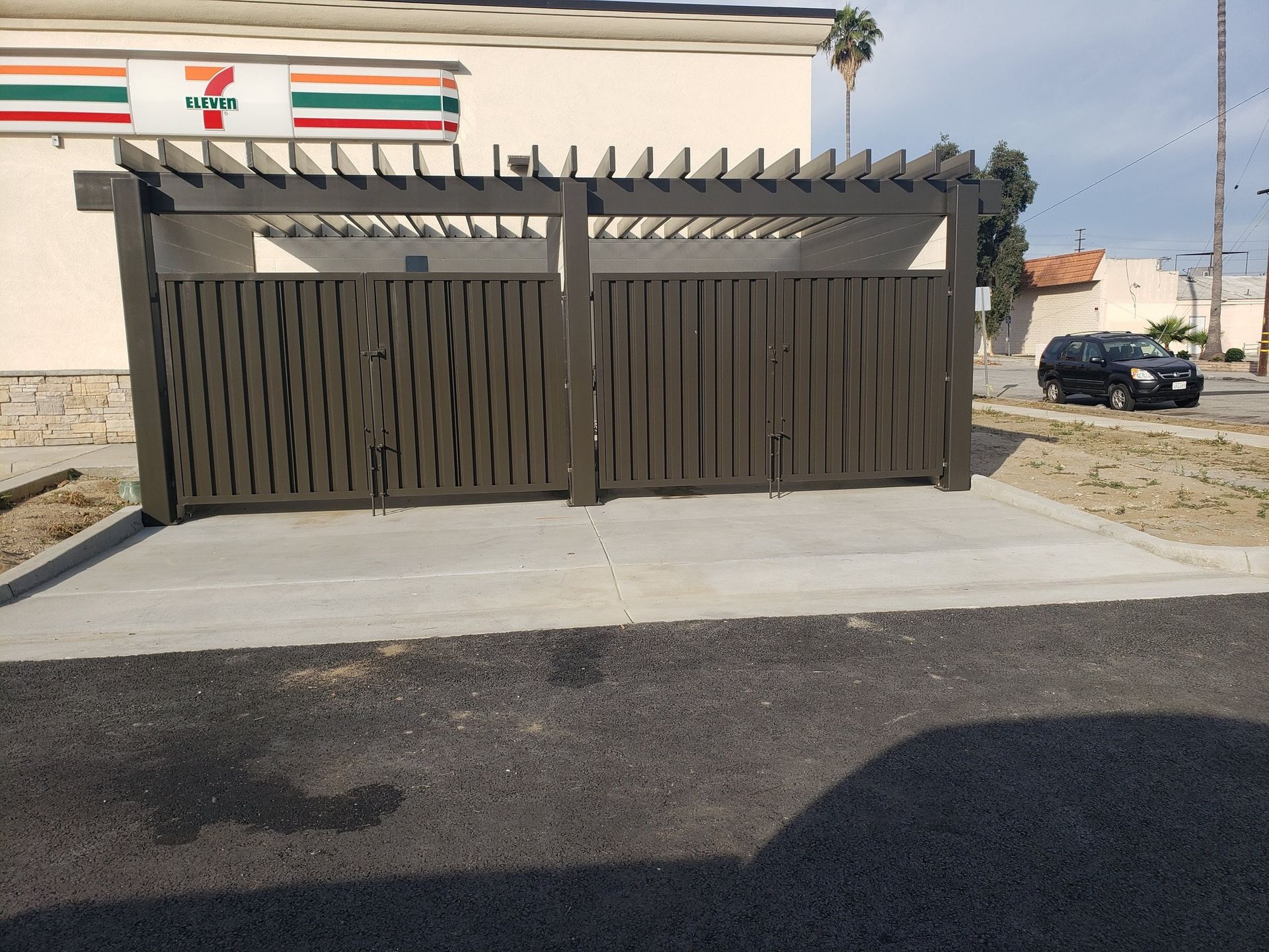 A 7 eleven store with a fence in front of it