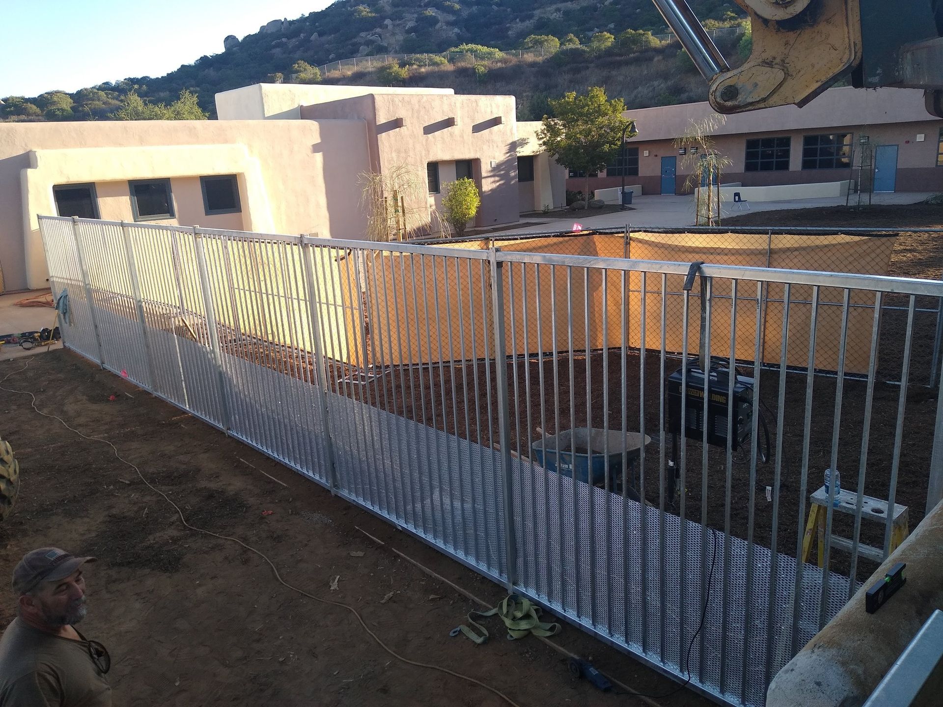 A metal fence is being built in front of a building