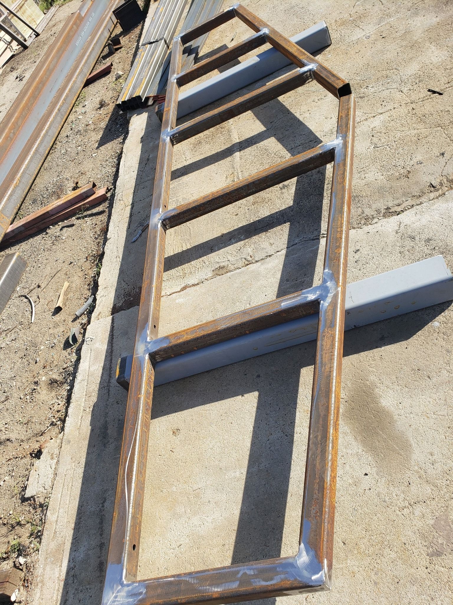 A metal frame is sitting on top of a concrete surface.
