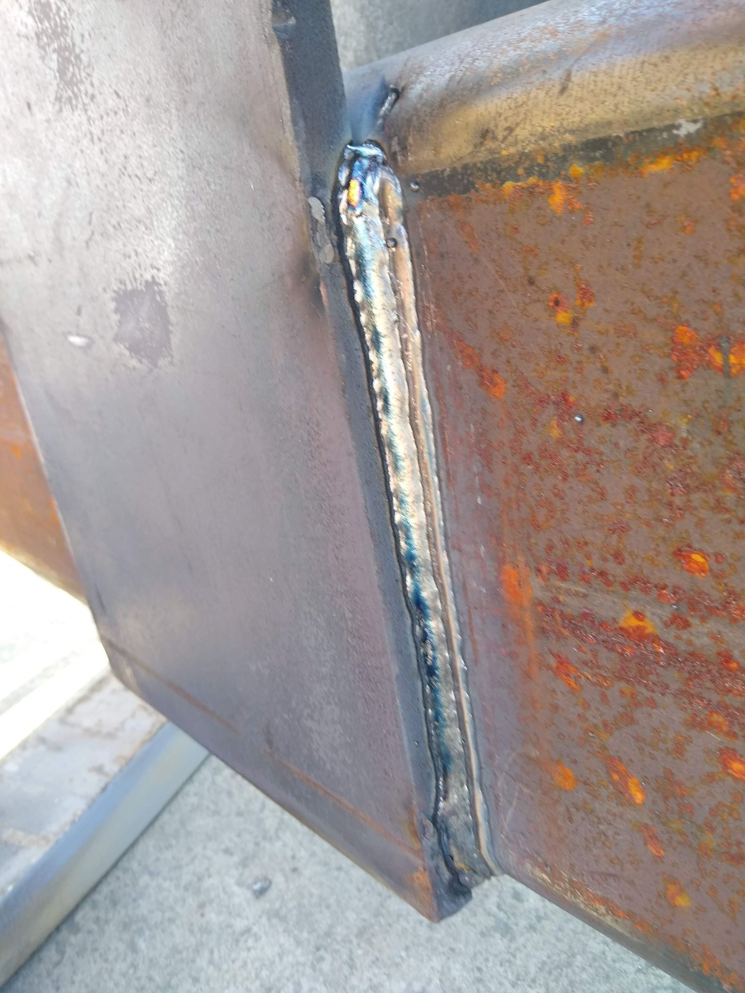 A close up of a piece of metal with a weld on it.