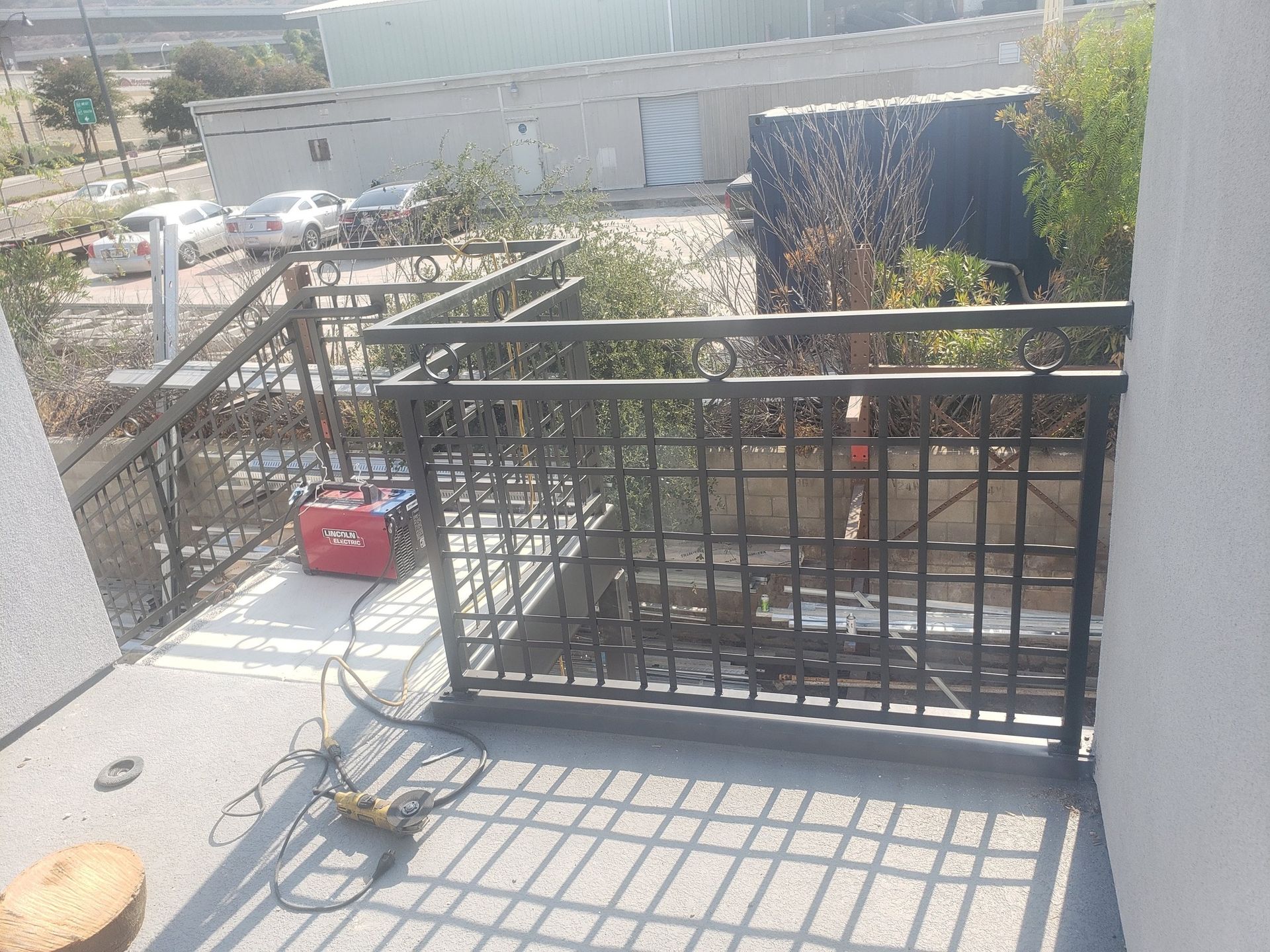 A balcony with a wrought iron railing is being built.