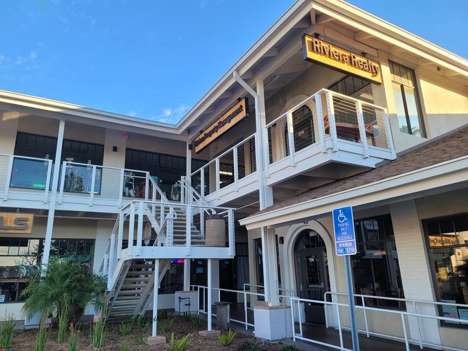 A large building with stairs leading up to the second floor.