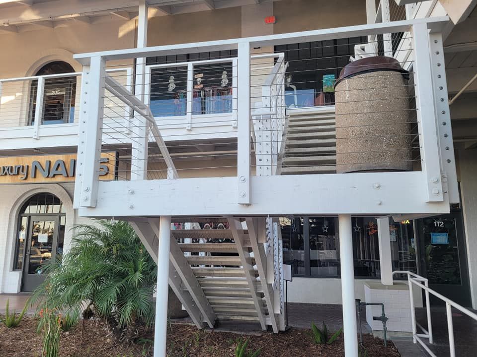 A building with stairs leading up to the second floor