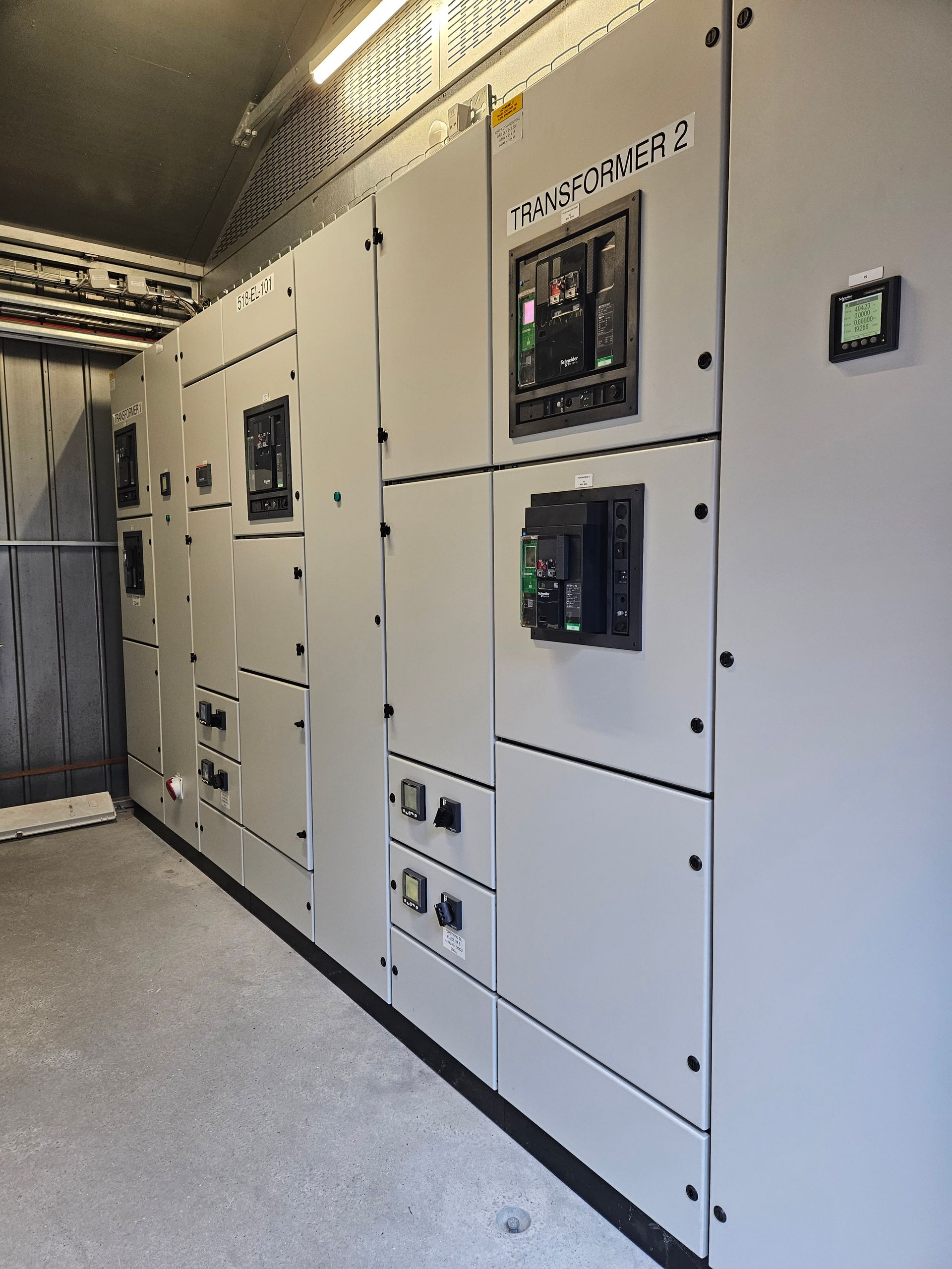 En række hvide el-tavler i et rum.