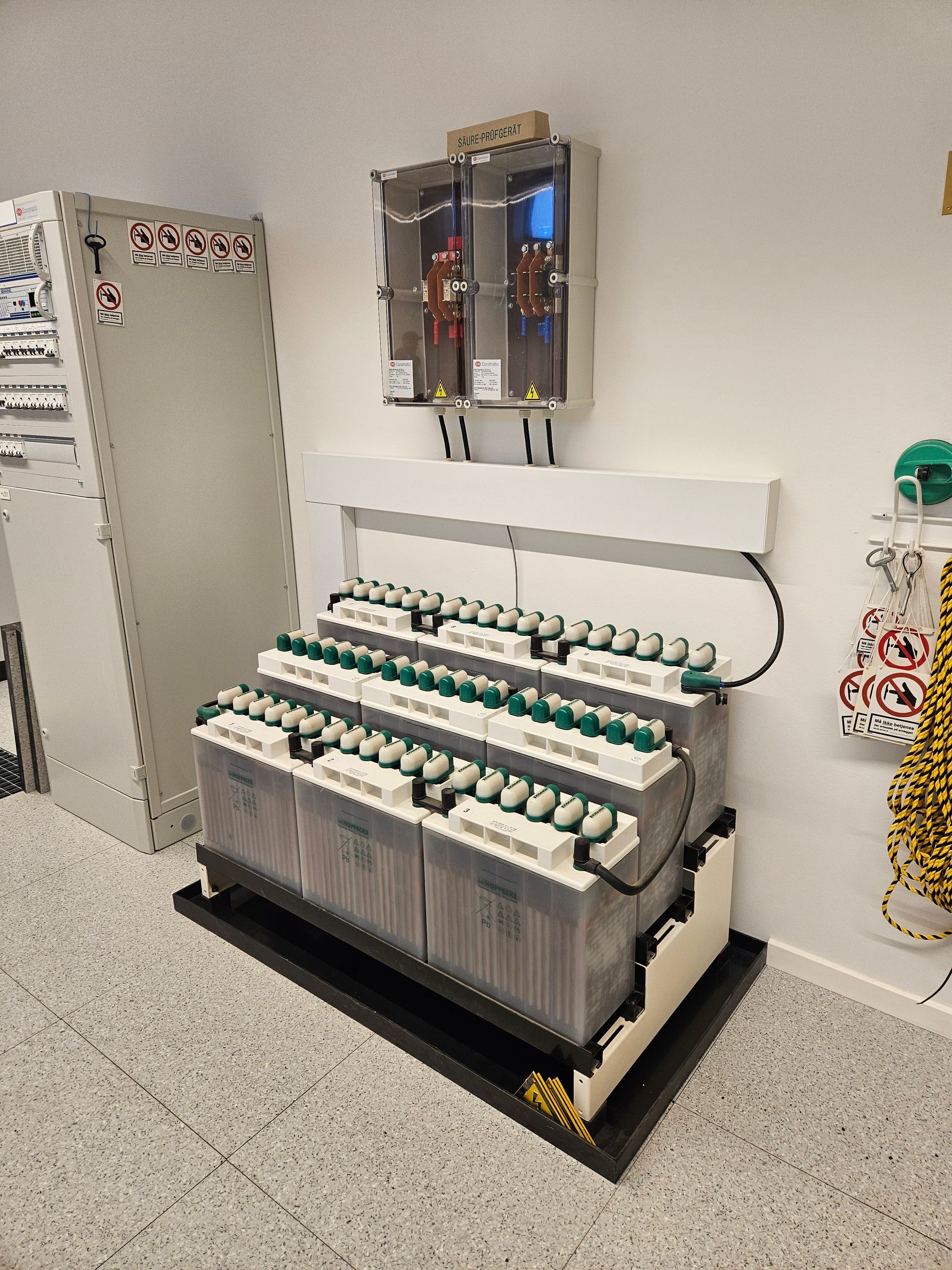 En masse batterier ligger på et bord i et værelse.