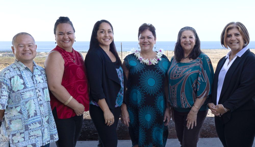 A group of people are posing for a picture together.