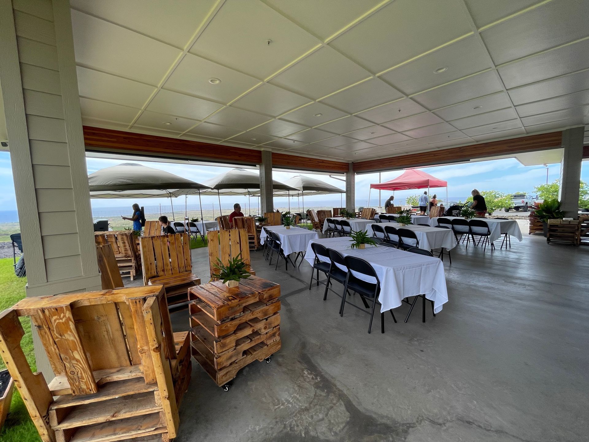 A large covered area with tables and chairs set up for a party.