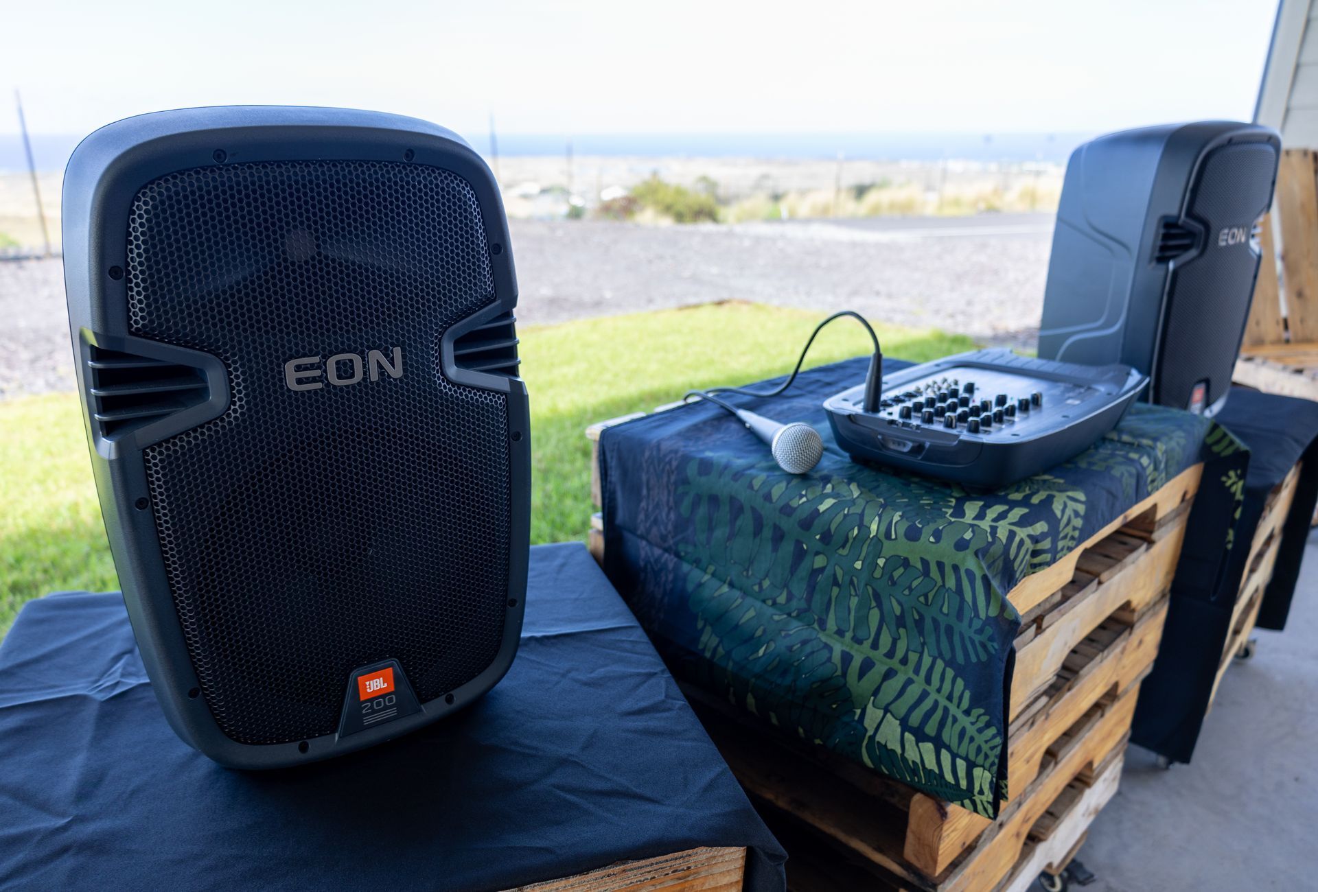 A couple of speakers sitting on top of a wooden table.