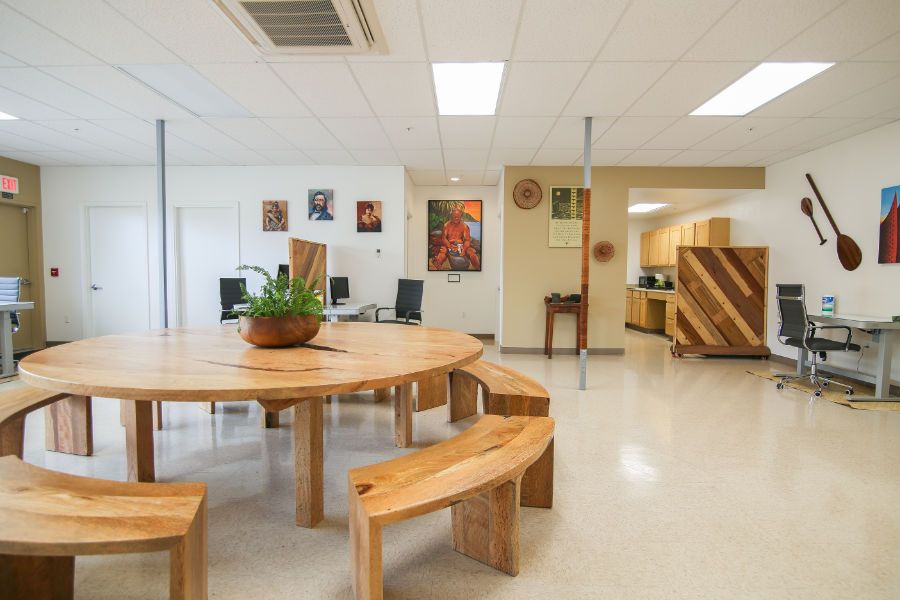 A large room with a table and benches in it