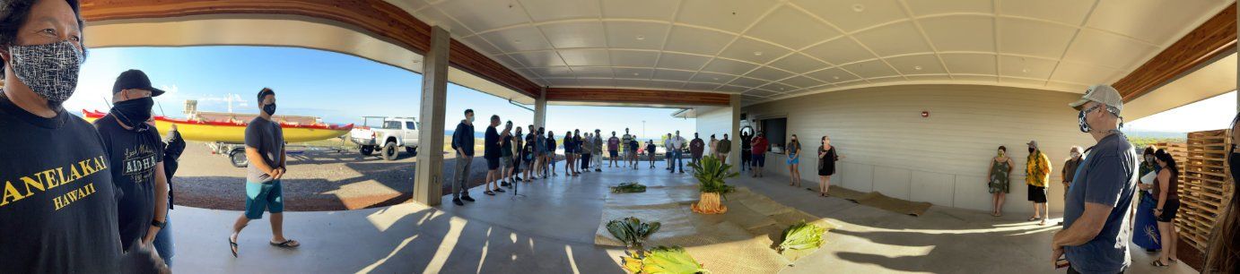 A group of people are standing in a large room.