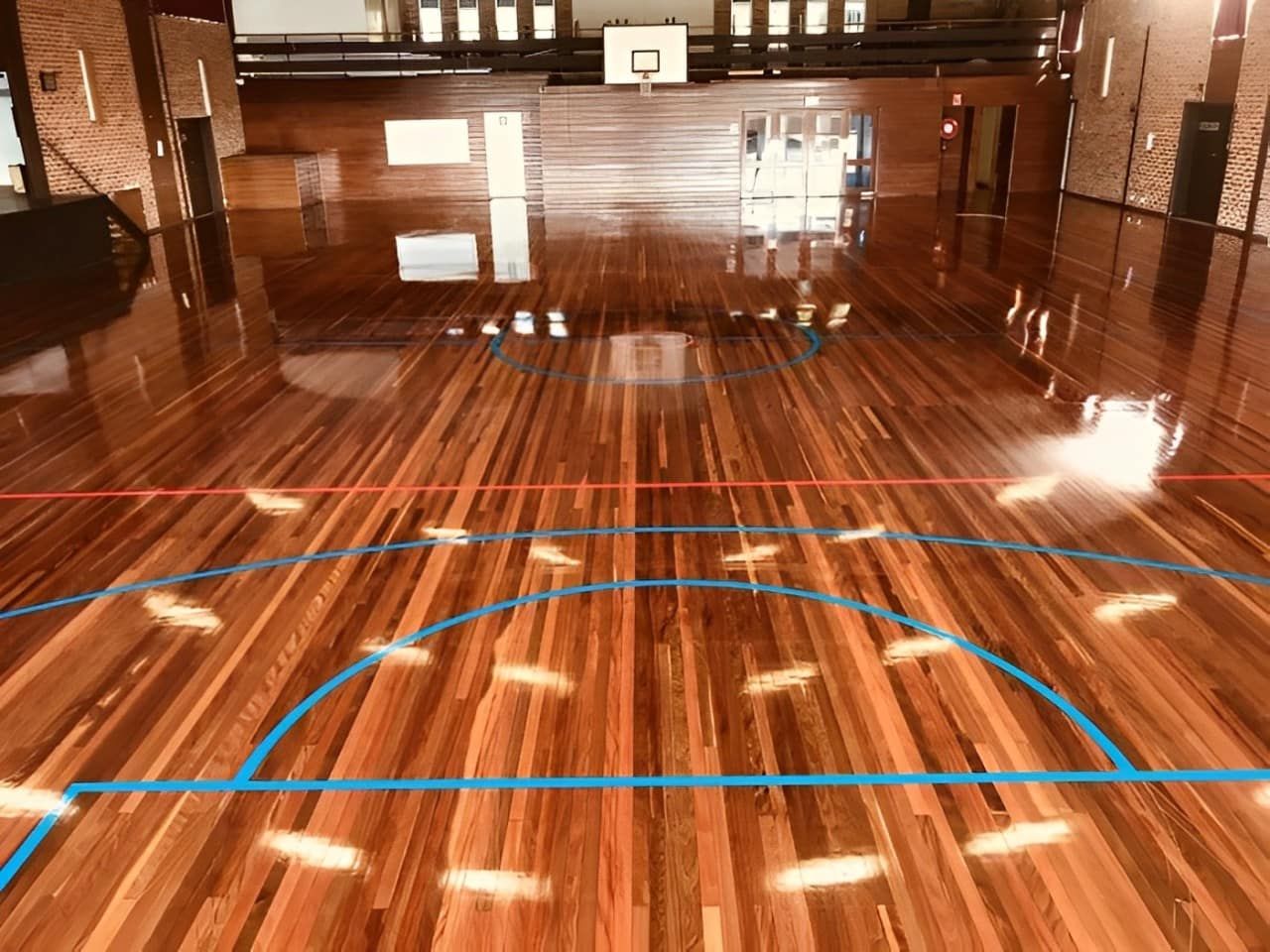 A Basketball Court With A Wooden Floor — Corbett Brothers Flooring In Woy Woy, NSW