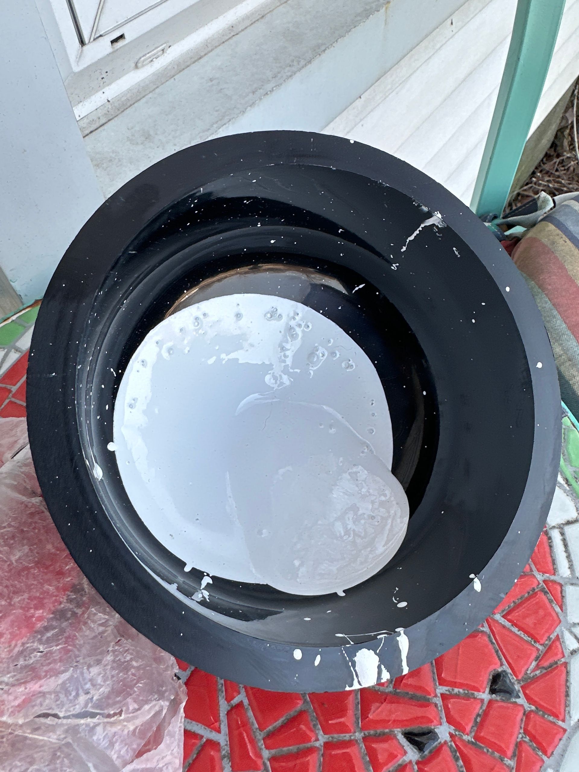 A black rubber ring with a white circle inside of it.