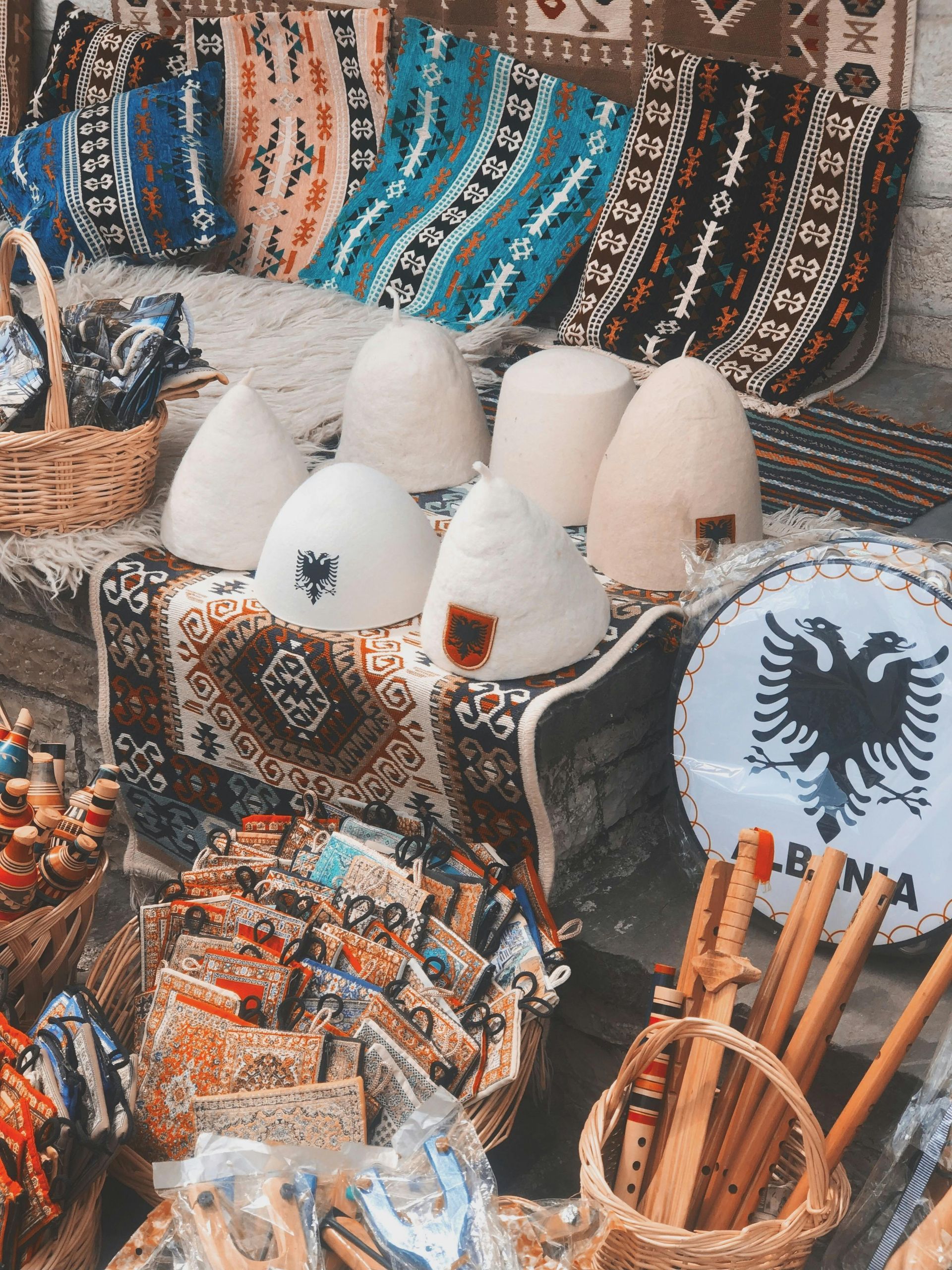 Green leaves and a partially opened walnut in its husk on a tree branch.