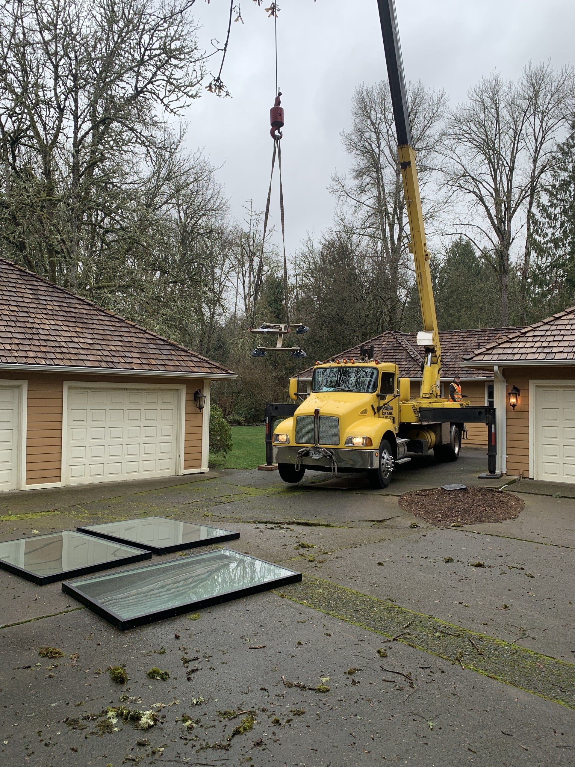 A Crane Truck Operating In Residential Houses — Beaverton, OR — Fulton Crane & Rigging