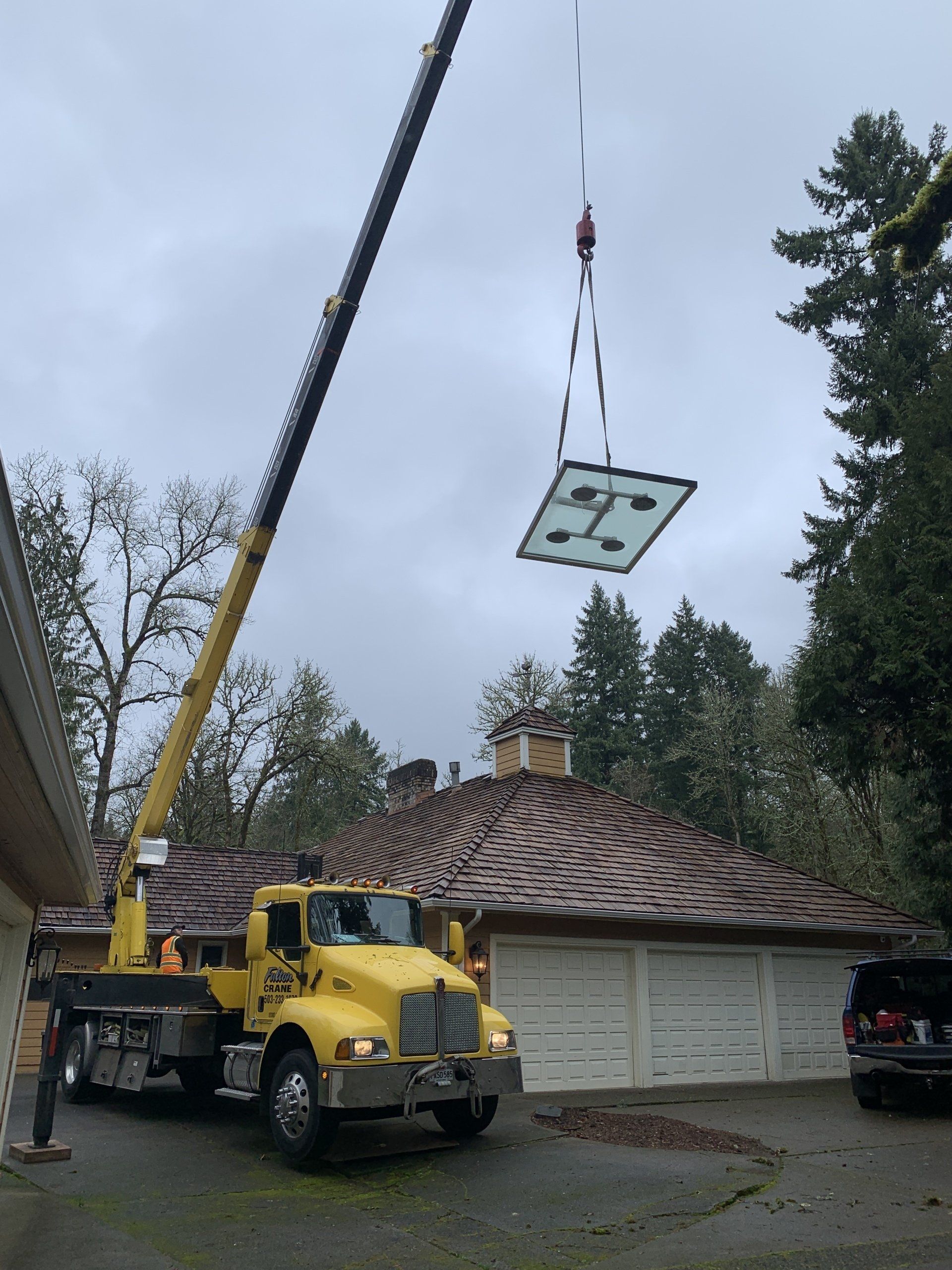 Front View Of Crane Truck Lifting A Glass — Beaverton, OR — Fulton Crane & Rigging