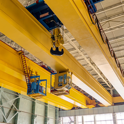 A crane is hanging from the ceiling of a building.