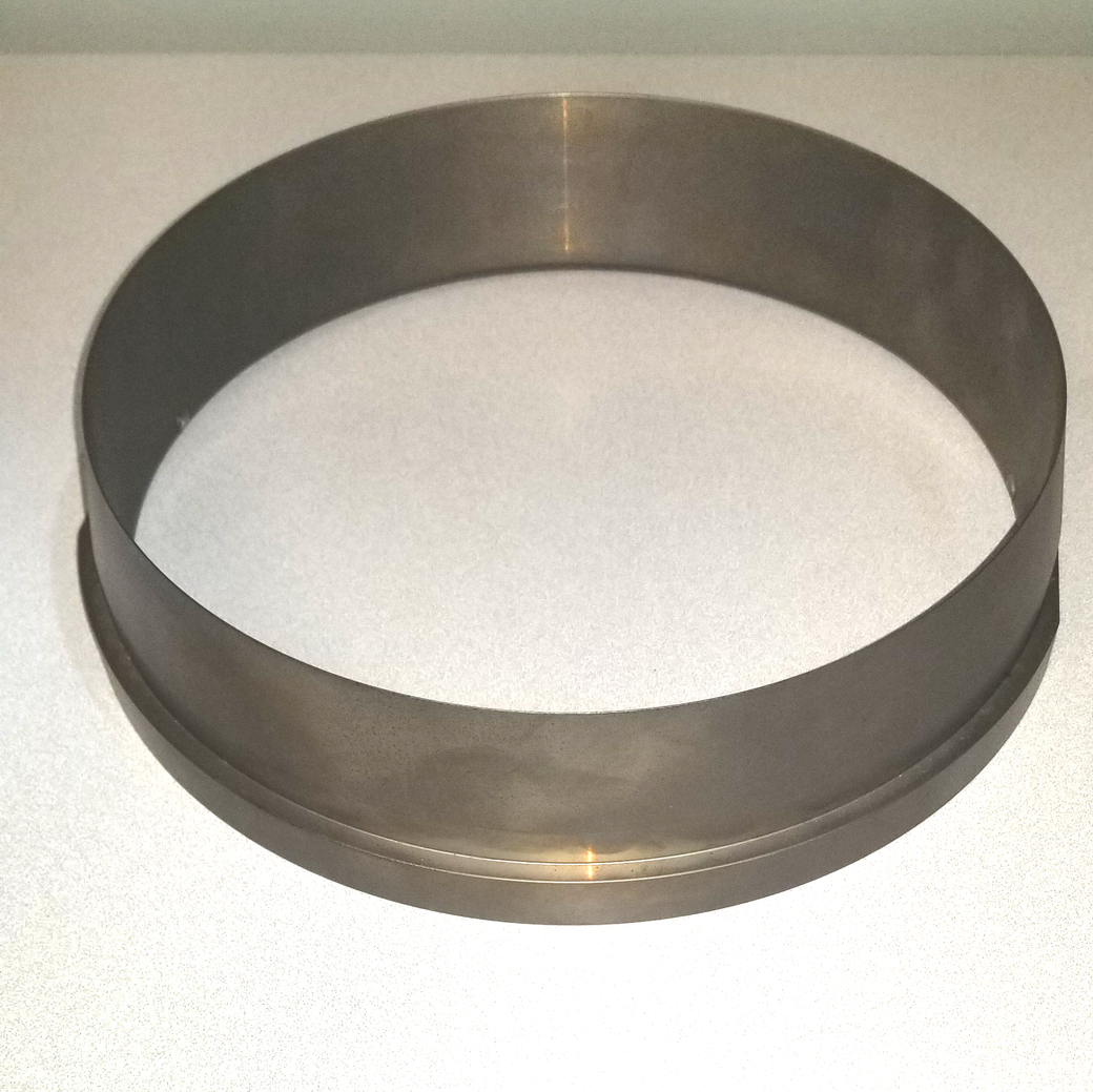 A metal ring is sitting on a white surface