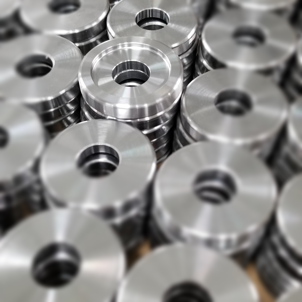 A bunch of metal rings with holes in them are stacked on top of each other.