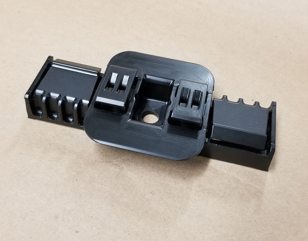 A black plastic object is sitting on a table.