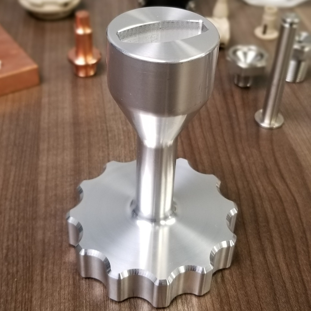 A silver metal object is sitting on a wooden table