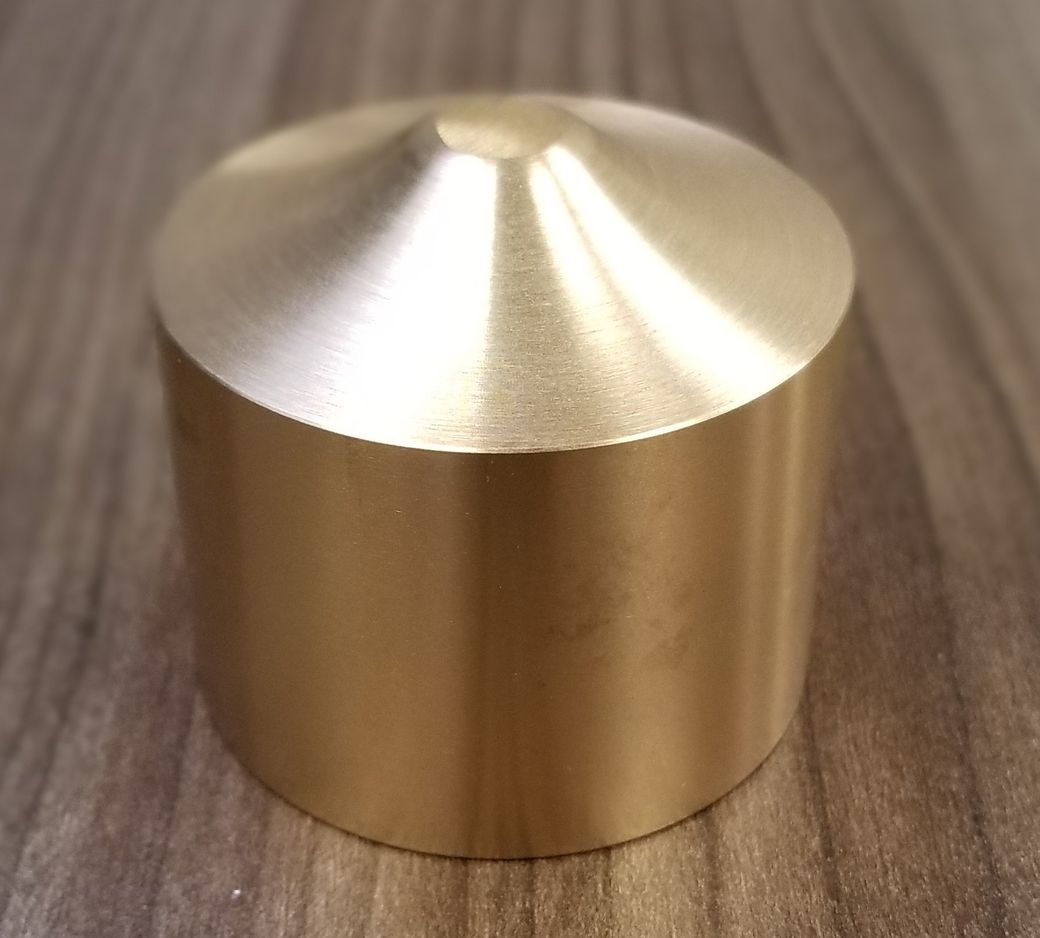 A brass object is sitting on a wooden table