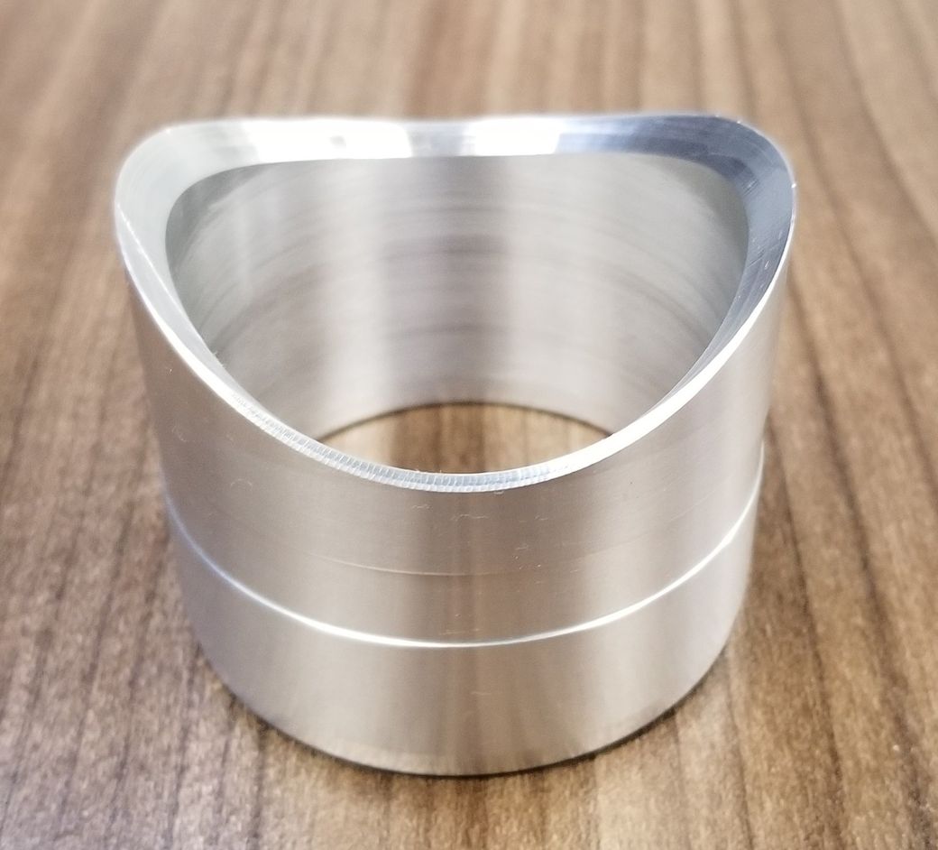 A metal ring is sitting on a wooden table