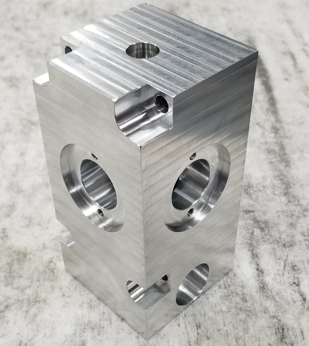 A piece of metal with holes in it is sitting on a table.