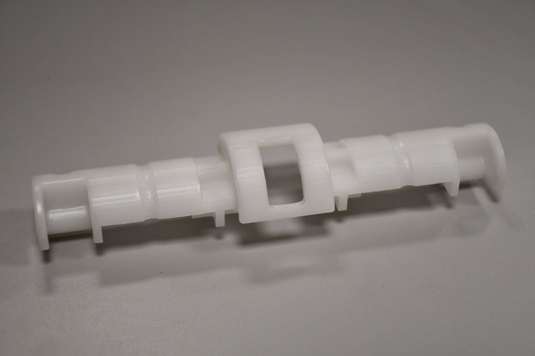A white plastic object is sitting on a table.