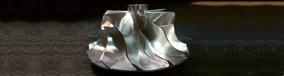 A close up of a metal object on a black surface.