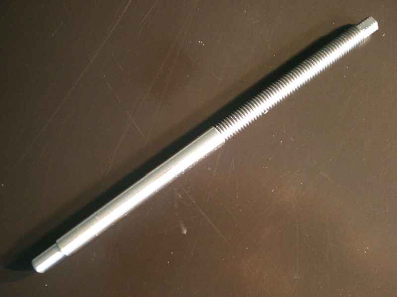 A metal rod is sitting on top of a wooden table.