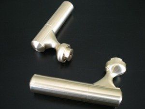 A pair of metal handles on a black surface