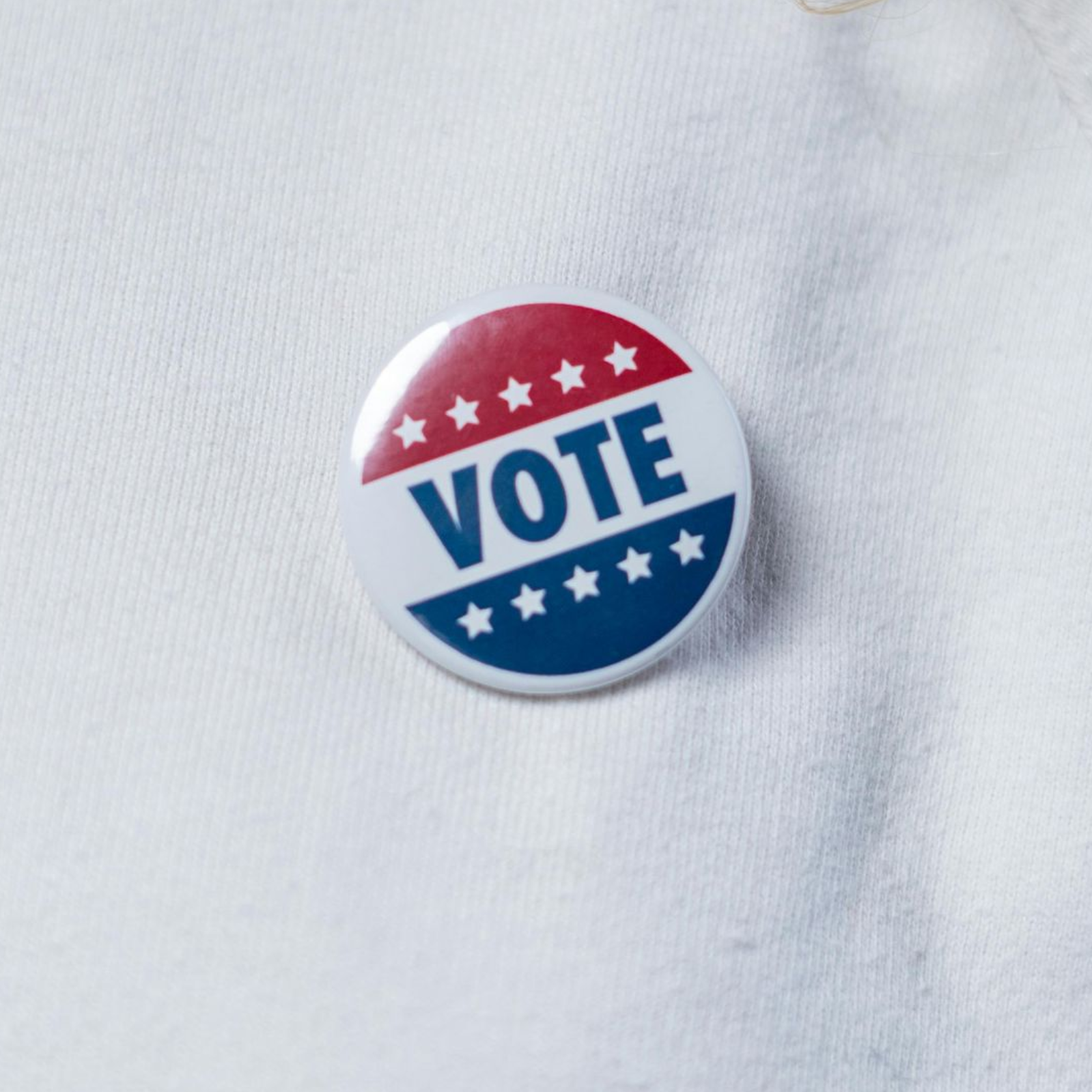 Button with red, white, and blue design that says 