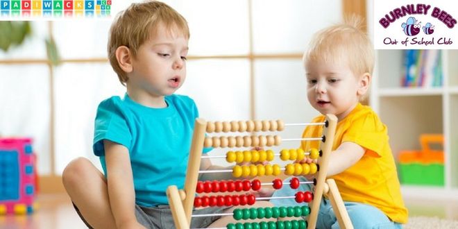 two young boys using an abacus