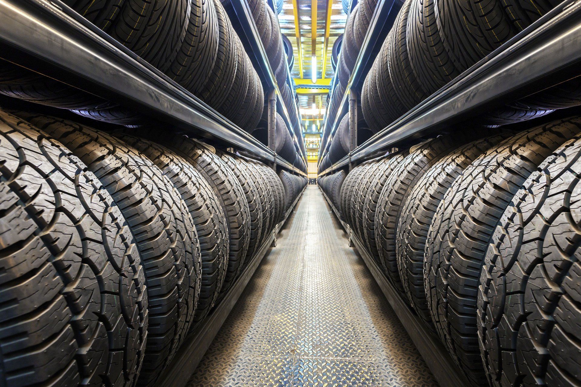 A warehouse filled with lots of tires on shelves.