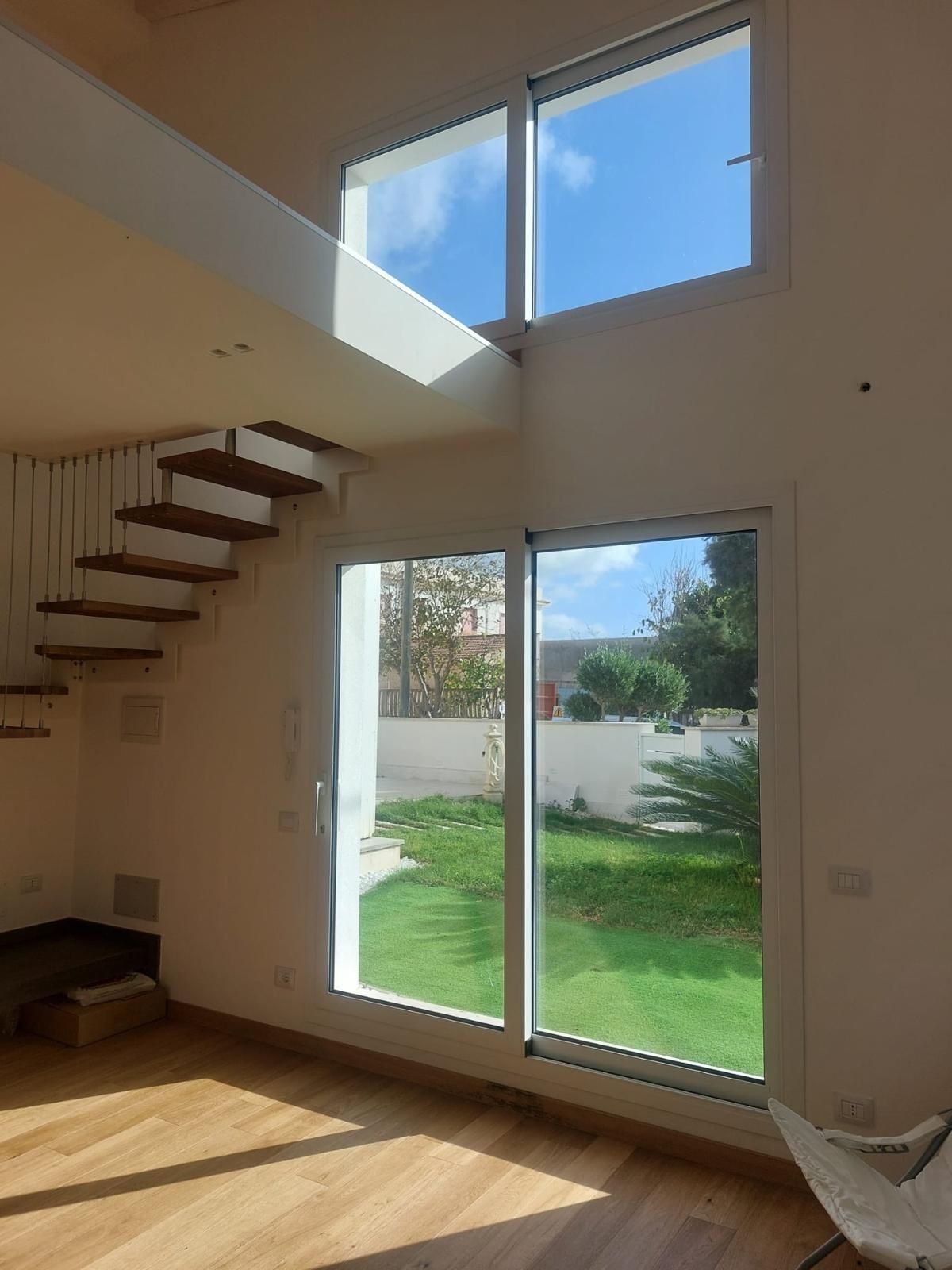 Assortimento di porte e finestre in vari stili e colori, esposte su uno sfondo bianco.