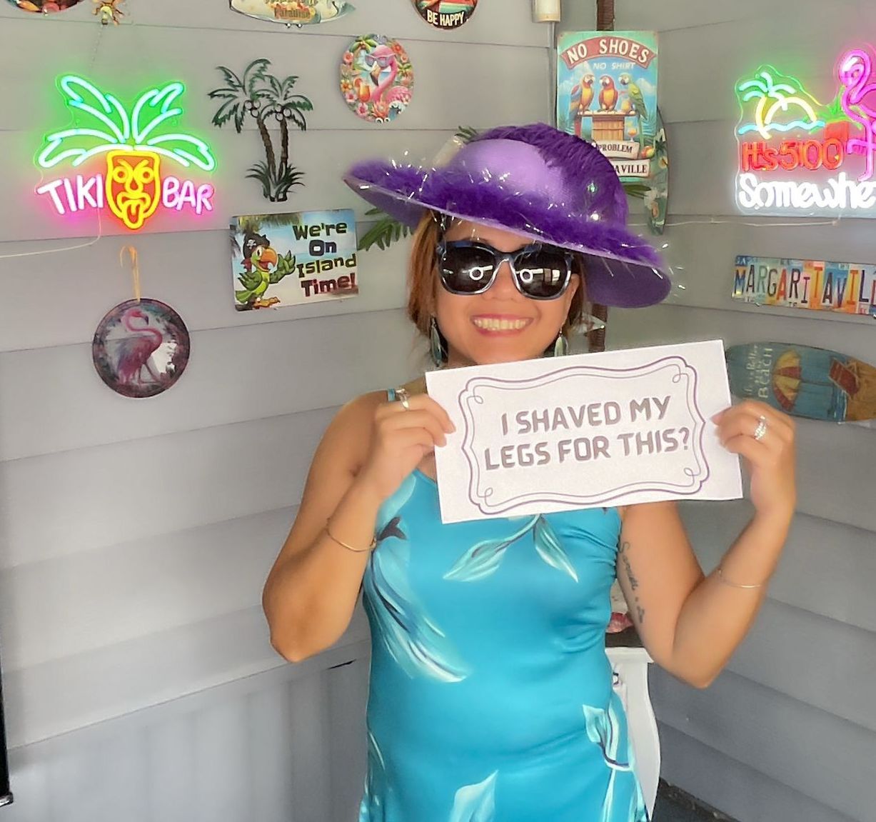 A woman holding a sign that says i shaved my legs for this