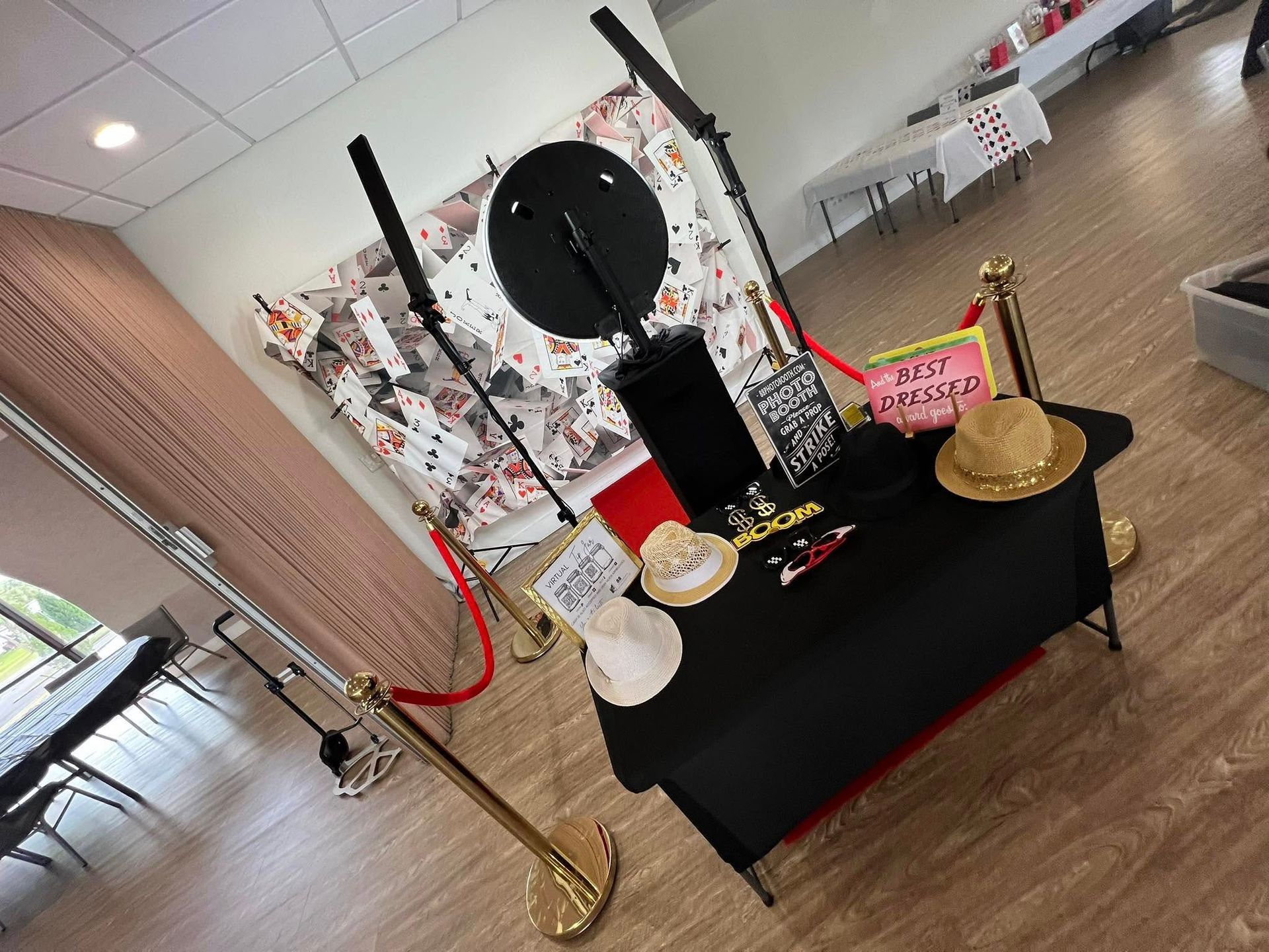 A photo booth is set up in a room with a red carpet.