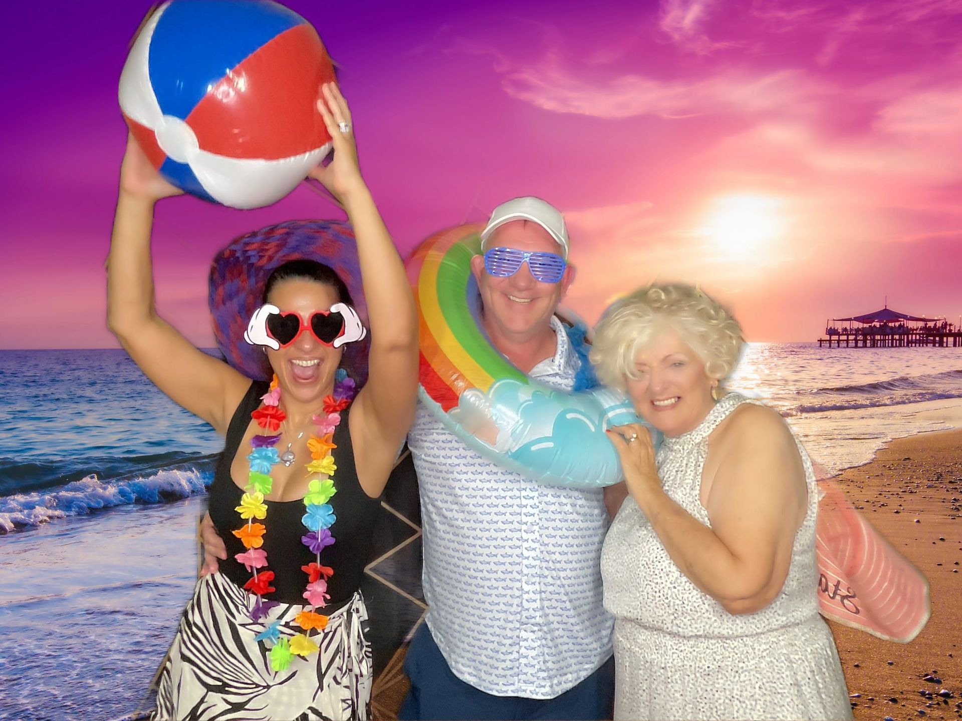 Alt: Beach-themed photo booth rental setup with custom backdrop, props, and instant print station at