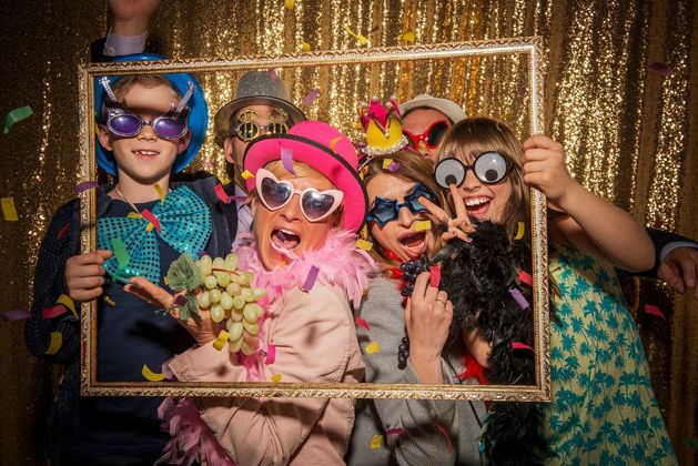 A group of people are celebrating the new year 's eve with sparklers and champagne.