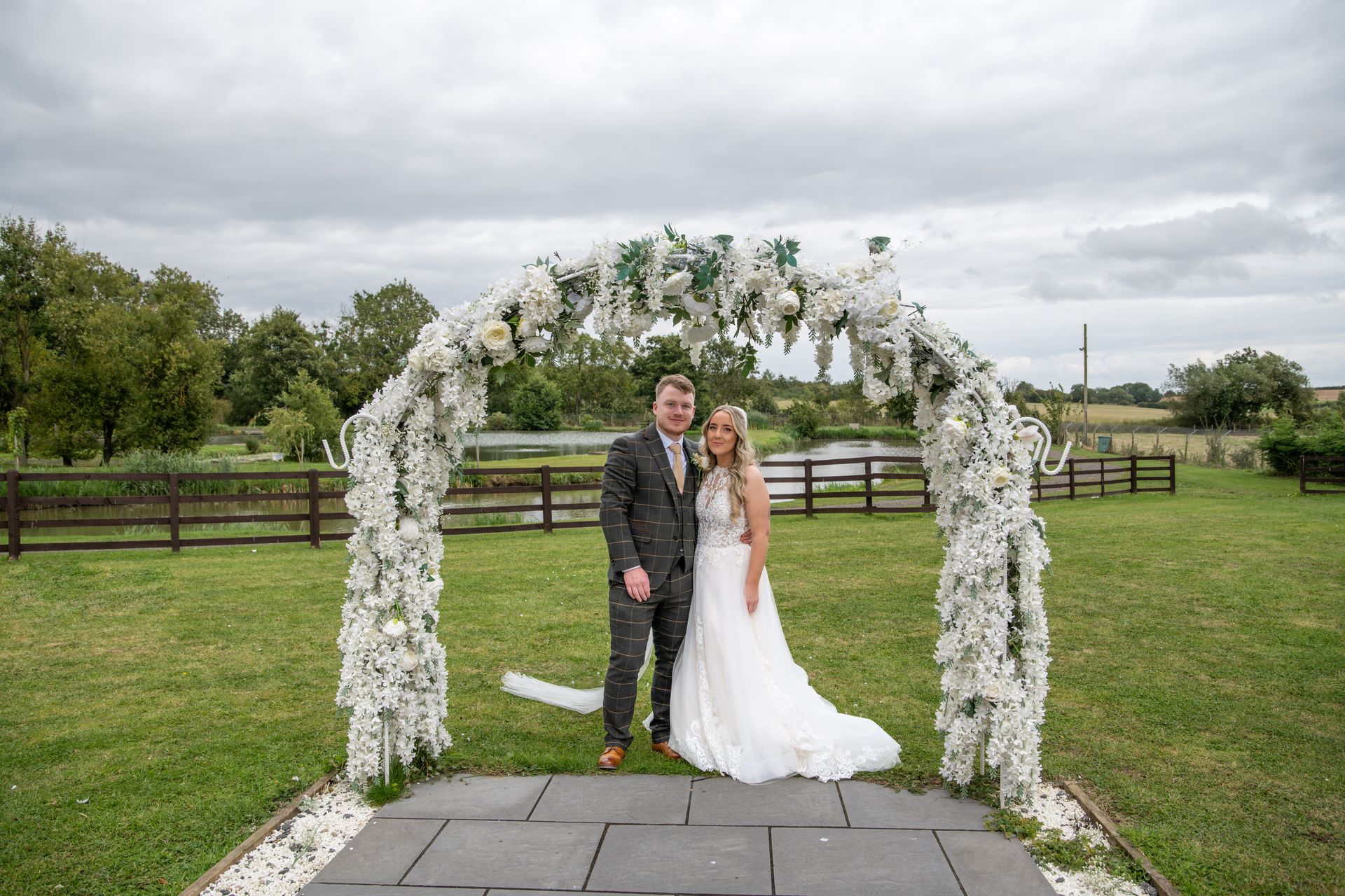 LS Photography - Trusted wedding photographer, archway flowers