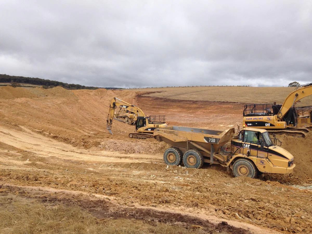 Dump Truck and Excavator in Construction Site — Marulan, NSW — Coopers Earthmoving Pty Ltd