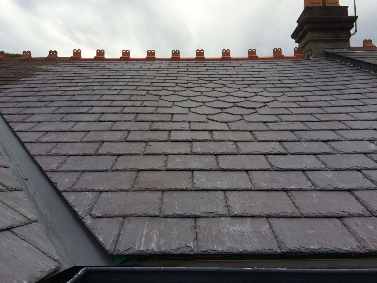 Immaculate slate roof adorning a stunning house, with its deep gray hues adding a touch of elegance and timeless beauty.