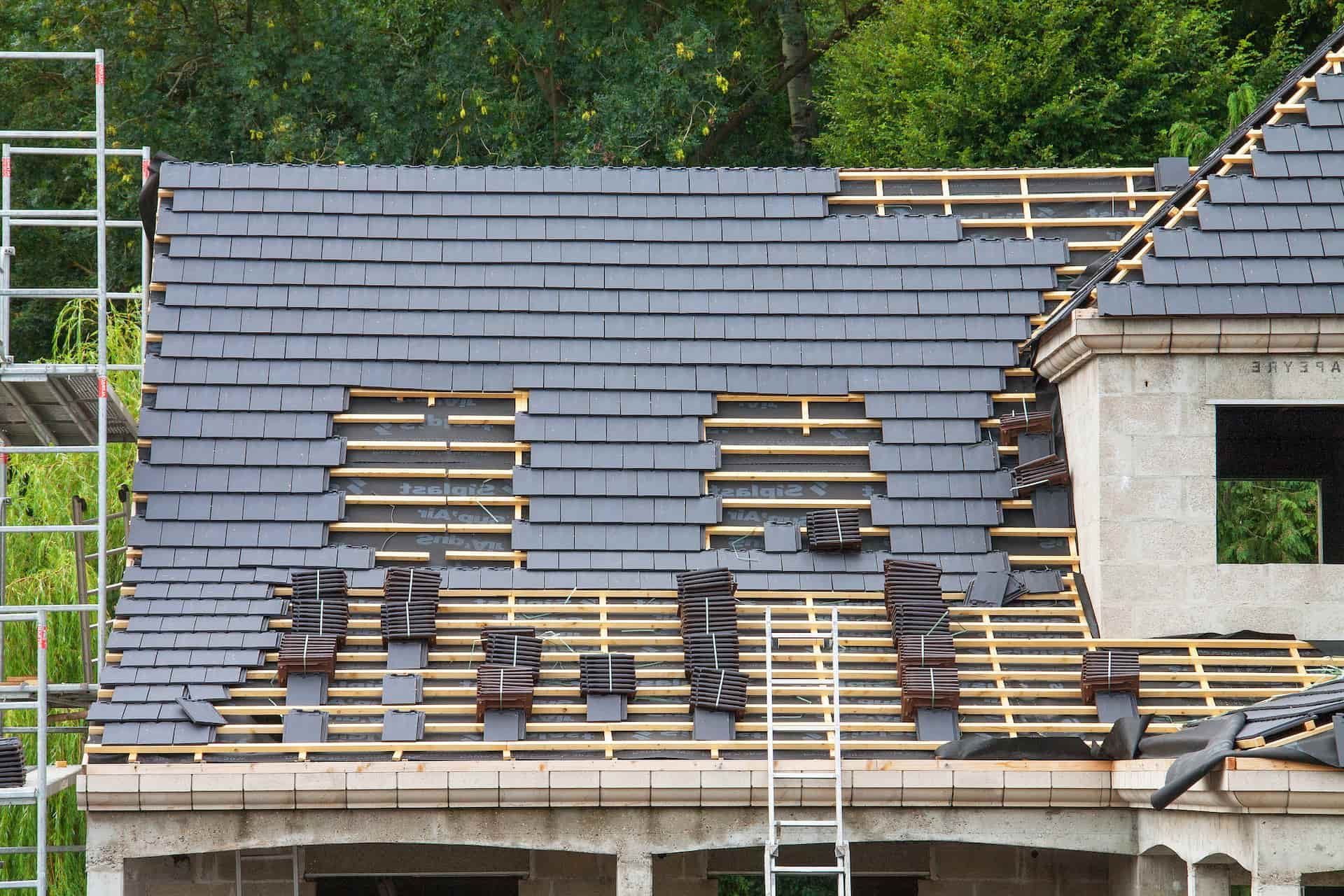 Professionals in protective suits carefully removing asbestos-cement.