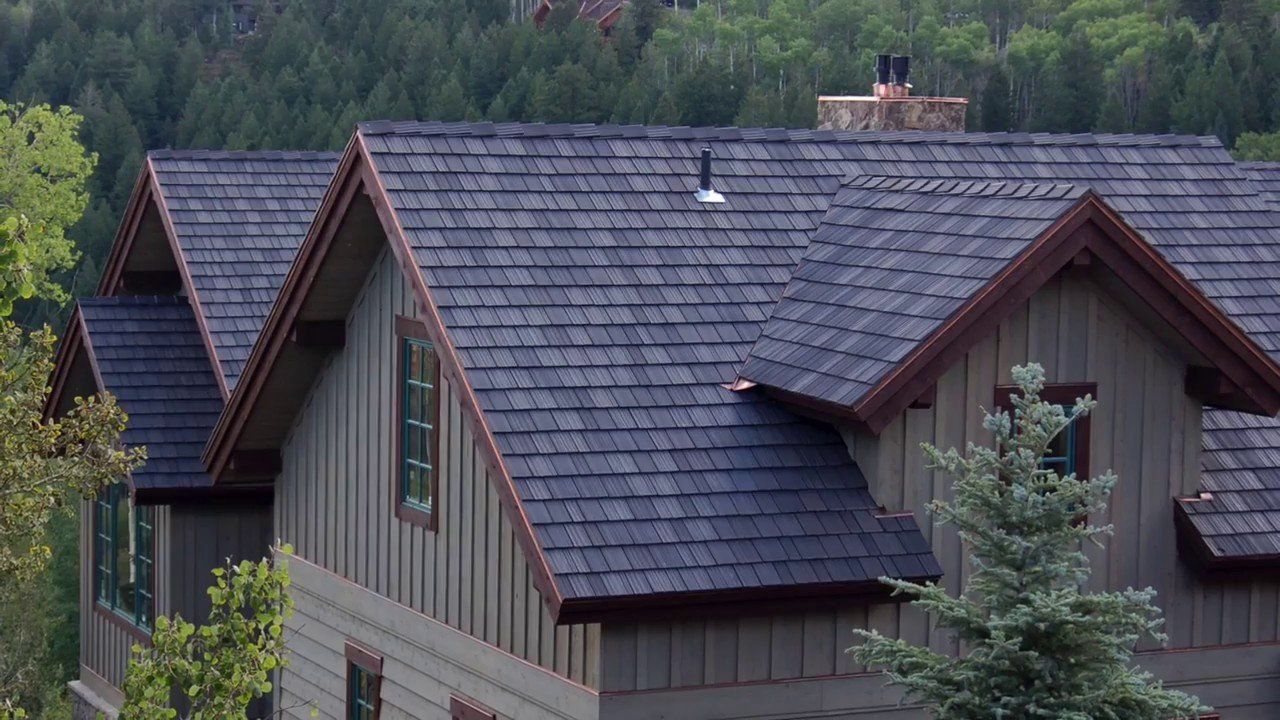 A shingle roof with overlapping rectangular asphalt shingles.