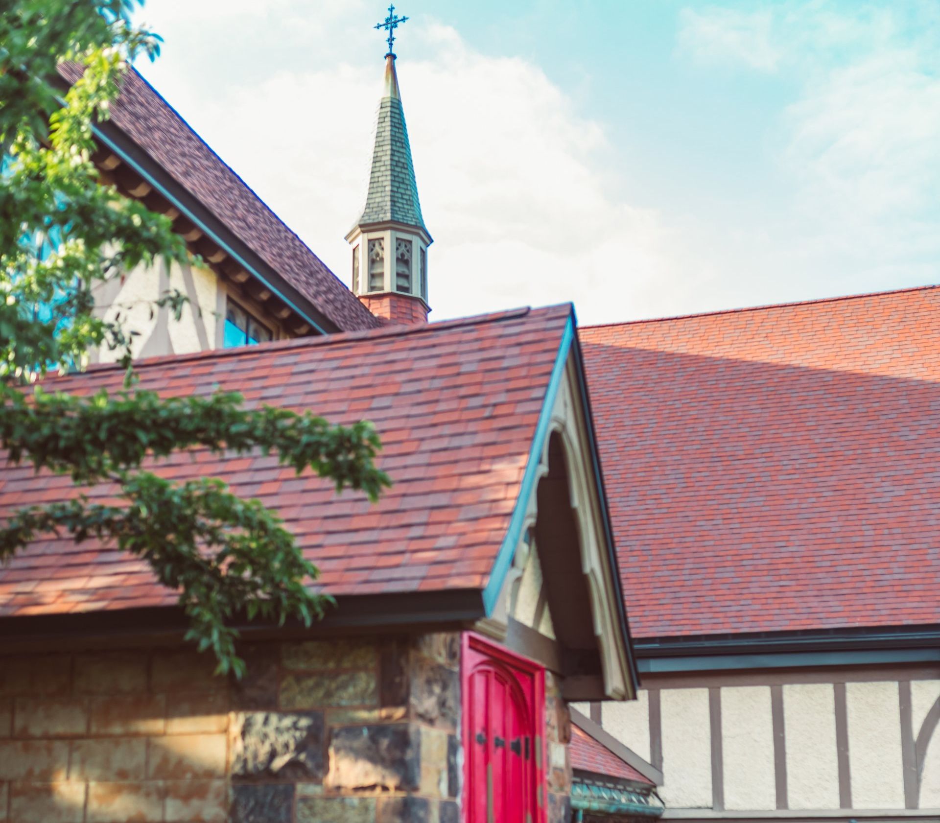 A house with a well-maintained fascia showcasing a shingle roof and brick siding.
